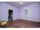 Hardwood floors in this bedroom featuring a ceiling fan and doorway leading outside at 6539 E Strickland St, Douglasville, GA 30134