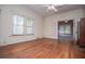 This bedroom has hardwood floors and good light from the windows at 6539 E Strickland St, Douglasville, GA 30134
