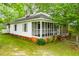 Charming home with a screened-in porch, surrounded by lush greenery at 6539 E Strickland St, Douglasville, GA 30134