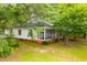Charming home featuring a screened-in front porch, offering a relaxing outdoor space and curb appeal at 6539 E Strickland St, Douglasville, GA 30134
