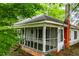 Charming home with a screened-in porch and a red brick chimney at 6539 E Strickland St, Douglasville, GA 30134