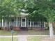 A cozy one-story home with a screened-in porch and a classic brick foundation at 6539 E Strickland St, Douglasville, GA 30134