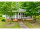 This home has a screened-in porch, green lawn, and a brick foundation at 6539 E Strickland St, Douglasville, GA 30134