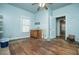 Galley style kitchen with natural wood cabinetry, shelving and wood flooring at 6539 E Strickland St, Douglasville, GA 30134