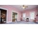 This spacious living room has lots of doorways, ceiling fan and natural light from the window at 6539 E Strickland St, Douglasville, GA 30134
