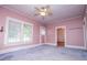 Bright living room featuring original trim, ceiling fan and natural light from exterior window at 6539 E Strickland St, Douglasville, GA 30134