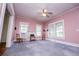 Spacious living room with ceiling fan, multiple windows, and original architectural trim details at 6539 E Strickland St, Douglasville, GA 30134