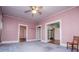 Spacious living room featuring ceiling fan, and doorways leading to other rooms at 6539 E Strickland St, Douglasville, GA 30134