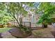 Landscaped backyard with a stone pathway leading to the deck at 1017 Mill Creek Ne Mnr, Brookhaven, GA 30319