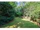 Expansive backyard featuring a well-maintained lawn and mature trees at 1017 Mill Creek Ne Mnr, Brookhaven, GA 30319