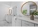 Bathroom featuring and vanities with marble countertops and round mirrors at 1017 Mill Creek Ne Mnr, Brookhaven, GA 30319