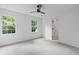 Well-lit bedroom with two windows providing natural light, includes neutral carpet and ceiling fan at 1017 Mill Creek Ne Mnr, Brookhaven, GA 30319