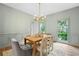 Elegant dining room with modern lighting, neutral color scheme, and lots of natural light at 1017 Mill Creek Ne Mnr, Brookhaven, GA 30319