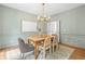 Elegant dining room with stylish chandelier, wood table, and wainscoting detail at 1017 Mill Creek Ne Mnr, Brookhaven, GA 30319