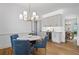 Cozy dining room with elegant chandelier, bar area, and view into additional dining space at 1017 Mill Creek Ne Mnr, Brookhaven, GA 30319
