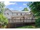 Back exterior view of the home highlighting the deck and screened porch at 1017 Mill Creek Ne Mnr, Brookhaven, GA 30319