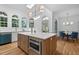 Open kitchen with a central island, stainless steel appliances, and light-filled arched windows at 1017 Mill Creek Ne Mnr, Brookhaven, GA 30319