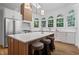 Bright, modern kitchen featuring a large island, stainless steel appliances, and arched windows at 1017 Mill Creek Ne Mnr, Brookhaven, GA 30319