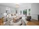 Bright living room with a neutral color palette and a large bay window showcasing the outdoor greenery at 1017 Mill Creek Ne Mnr, Brookhaven, GA 30319