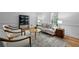 Inviting living room with neutral decor and plush chairs around a wooden coffee table at 1017 Mill Creek Ne Mnr, Brookhaven, GA 30319