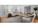 Cozy living room with hardwood floors, neutral furniture, and large windows for natural light at 1017 Mill Creek Ne Mnr, Brookhaven, GA 30319