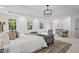 Large main bedroom with tray ceilings, plush seating, and view of backyard at 1017 Mill Creek Ne Mnr, Brookhaven, GA 30319