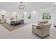 Large main bedroom with tray ceilings, plush seating, and view of backyard at 1017 Mill Creek Ne Mnr, Brookhaven, GA 30319