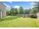 Expansive backyard with lush green grass, mature trees, and a charming seating area, perfect for outdoor entertaining at 2767 Nw Magnolia Creek Dr, Kennesaw, GA 30152