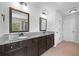 Primary bathroom boasts double vanities, granite countertops, and dark wood cabinetry at 2767 Nw Magnolia Creek Dr, Kennesaw, GA 30152