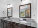 Elegant bathroom features a dual vanity with granite countertops and bronze framed mirrors at 2767 Nw Magnolia Creek Dr, Kennesaw, GA 30152