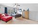 Bright bedroom with a window, stylish red chair, and a unique wooden dresser at 2767 Nw Magnolia Creek Dr, Kennesaw, GA 30152