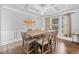 Spacious dining room featuring a decorative ceiling, pendant lighting, and large windows at 2767 Nw Magnolia Creek Dr, Kennesaw, GA 30152
