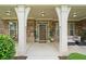Welcoming front entrance with a covered porch, stone columns, and neatly manicured landscaping, adding to the home's charm at 2767 Nw Magnolia Creek Dr, Kennesaw, GA 30152