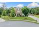 Beautifully landscaped home with a stone facade, inviting covered porch, and spacious driveway, nestled in a serene neighborhood at 2767 Nw Magnolia Creek Dr, Kennesaw, GA 30152