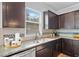 A close-up of a kitchen featuring granite countertops, stainless steel appliances, and stylish backsplash at 2767 Nw Magnolia Creek Dr, Kennesaw, GA 30152