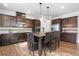 Well-appointed kitchen features dark cabinetry, stainless steel appliances, granite countertops, and a kitchen island with seating at 2767 Nw Magnolia Creek Dr, Kennesaw, GA 30152