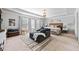 Airy main bedroom with a tray ceiling, a large window, and a comfortable lounge area at 2767 Nw Magnolia Creek Dr, Kennesaw, GA 30152