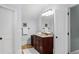 Bathroom featuring a dark wood vanity with double doors to the hallway at 2941 Elizabeth Se St, Smyrna, GA 30080