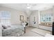 Bright bedroom boasts neutral colors, ceiling fan, window seat, and closet at 2941 Elizabeth Se St, Smyrna, GA 30080