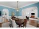 Dining room features stylish blue walls, wainscoting, and a modern gold chandelier at 2941 Elizabeth Se St, Smyrna, GA 30080
