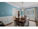 Inviting dining room with a dark wood table, neutral chairs, and plantation shutters at 2941 Elizabeth Se St, Smyrna, GA 30080