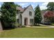 Well-maintained front yard of a painted brick home with mature trees and manicured landscaping at 2941 Elizabeth Se St, Smyrna, GA 30080