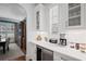 Wet bar with a beverage fridge, white cabinets, and a view into the dining room at 2941 Elizabeth Se St, Smyrna, GA 30080