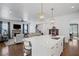 An open concept kitchen with a large center island and a view into the living room with a stone fireplace at 2941 Elizabeth Se St, Smyrna, GA 30080