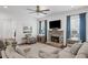 Spacious living room with a stone fireplace, comfortable seating, and lots of natural light at 2941 Elizabeth Se St, Smyrna, GA 30080