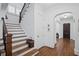 Beautiful staircase with dark wood railing, white risers, and hardwood floors at 2941 Elizabeth Se St, Smyrna, GA 30080