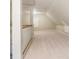 Empty attic with carpeted floors, white-painted beams, and a window for natural light at 150 Henderson Farm Dr, Woodstock, GA 30188
