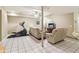 Finished basement area with tile flooring, sofas, elliptical machine, and ceiling fan at 150 Henderson Farm Dr, Woodstock, GA 30188
