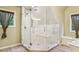 Elegant bathroom featuring a glass-enclosed shower with a bench, and decorative windows at 150 Henderson Farm Dr, Woodstock, GA 30188