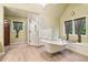 Bright bathroom showcasing glass shower, claw foot tub, stylish fixtures and tile flooring at 150 Henderson Farm Dr, Woodstock, GA 30188